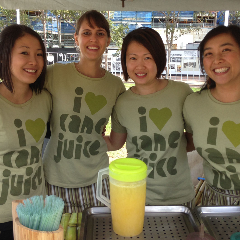Tall Grass Cane Juice's Team serving fresh juice at Festivals and Markets in Sydney